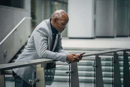 Black man browsing smartphone in business district