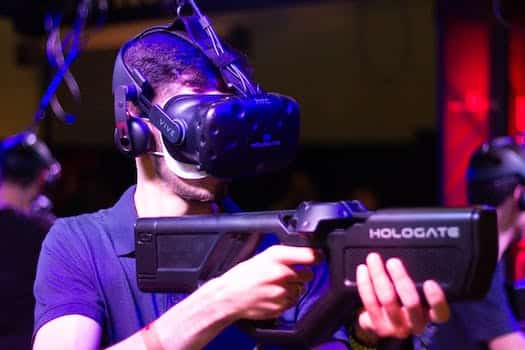Man in VR with game riffle playing video game