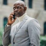 Serious black businessman talking on mobile phone