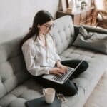 Woman Working At Home Using Laptop