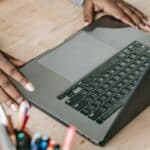 Black woman using laptop at table