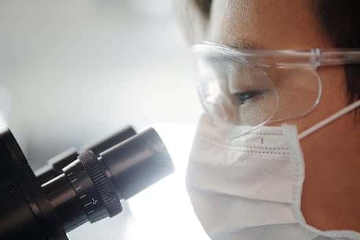 Man Looking Through A Microscope