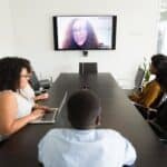 Diverse coworkers having online conference in modern office