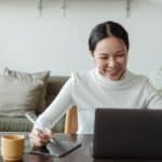 Woman working at home and making video call on laptop