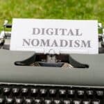 A typewriter with a paper that says digital nomadism